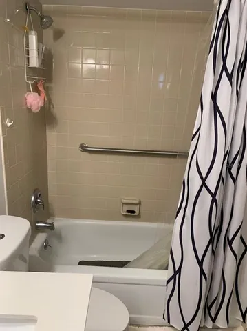 a bathroom with a bathtub and shower