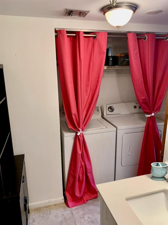 3006 Caring Way, Unit 417 Port Charlotte, FL 33952 - Photo 19 of 24 a view of a room with a washer and dryer