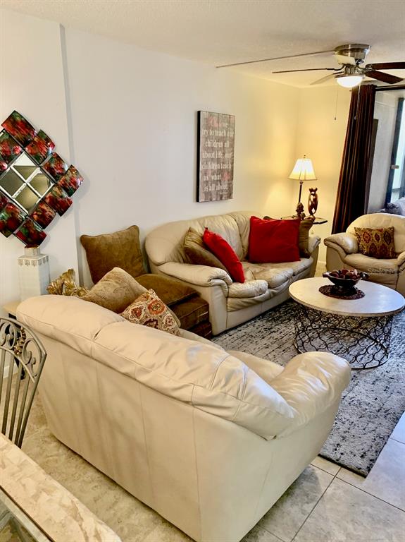 3006 Caring Way, Unit 417 Port Charlotte, FL 33952 - Photo 2 of 24 a living room with furniture and a flat screen tv