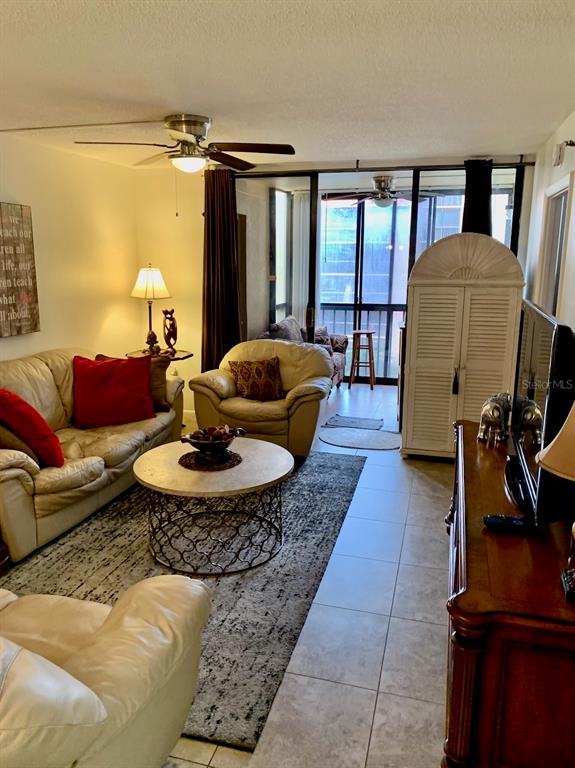 3006 Caring Way, Unit 417 Port Charlotte, FL 33952 - Photo 3 of 24 a living room with furniture and a fireplace