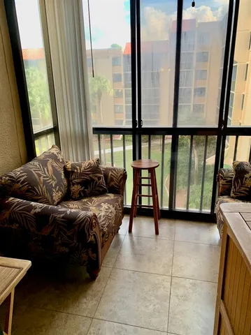 a living room with furniture and a floor to ceiling window