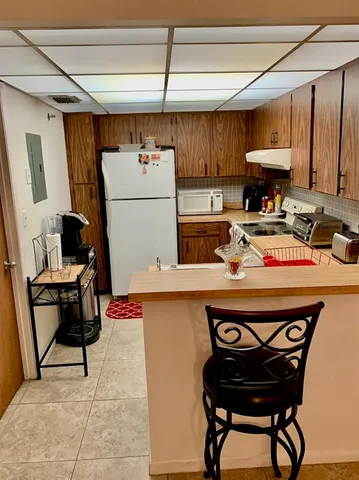 a kitchen with a appliances a stove and a refrigerator