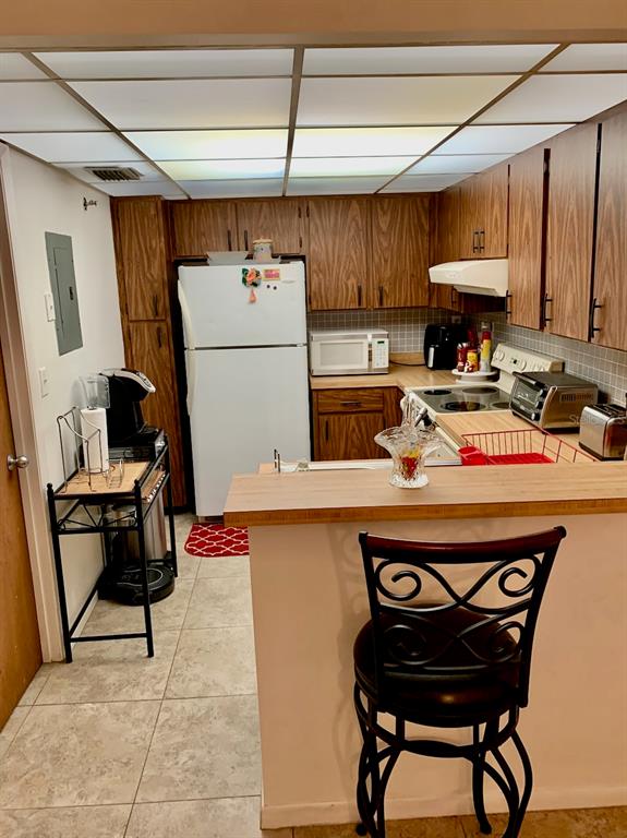 3006 Caring Way, Unit 417 Port Charlotte, FL 33952 - Photo 10 of 24 a kitchen with a appliances a stove and a refrigerator