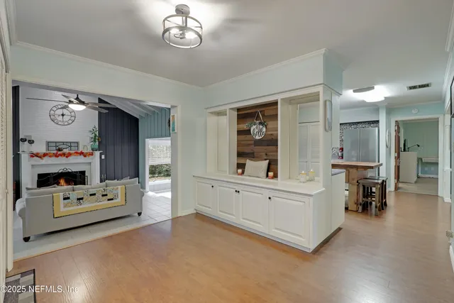 a kitchen with granite countertop a sink cabinets stainless steel appliances and a window