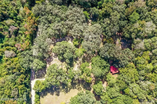 a view of a bedroom with furniture and window
