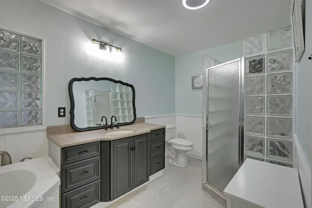 a dining room with furniture a chandelier and wooden floor