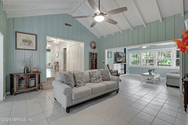 a view of a house with backyard and a tree