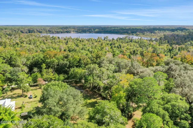 a view of a patio with table and chairs under an umbrella