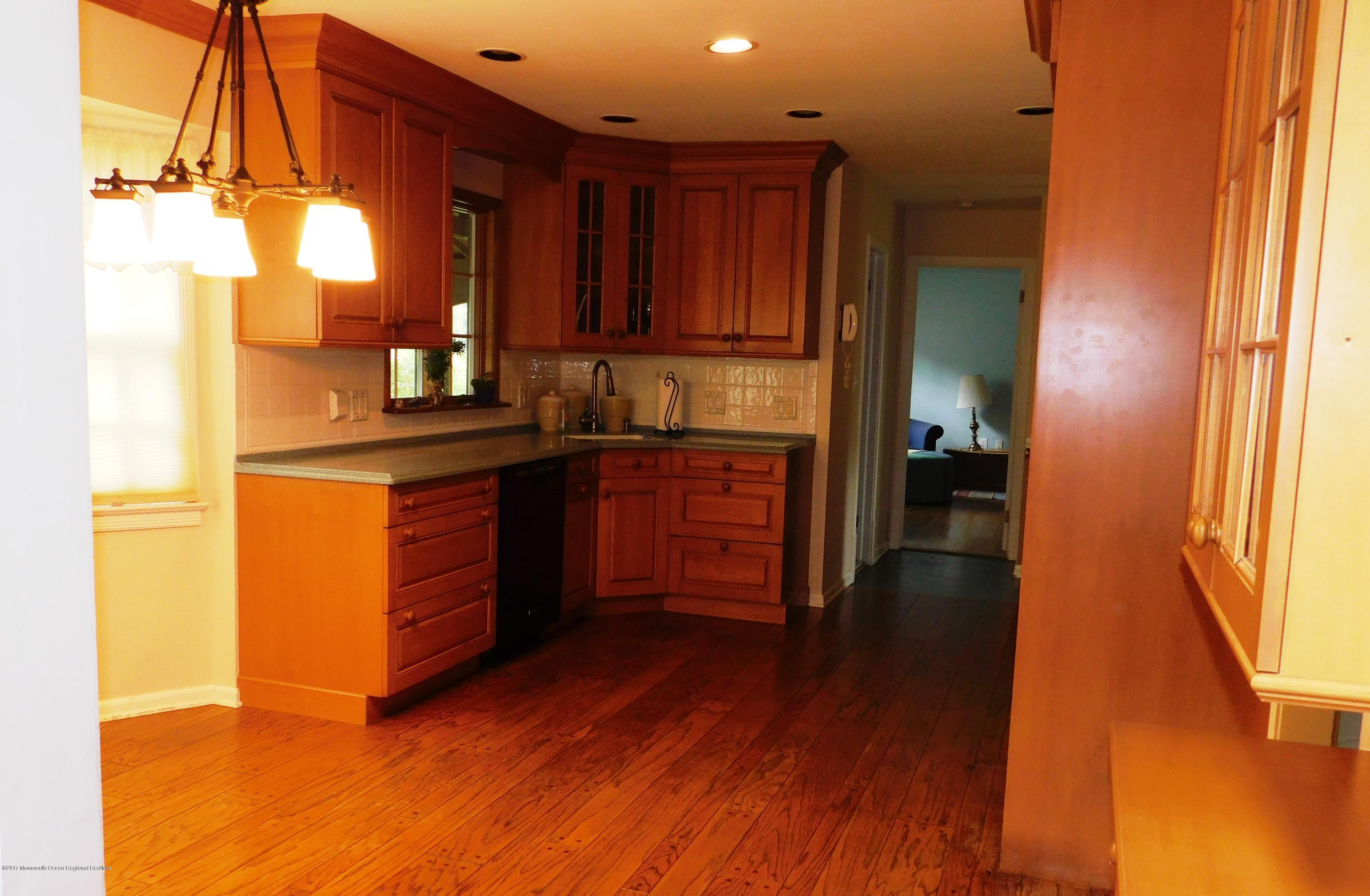 68 Stavola Road Middletown, NJ 07748 - Photo 12 of 49 a kitchen with wooden floors and wooden cabinets