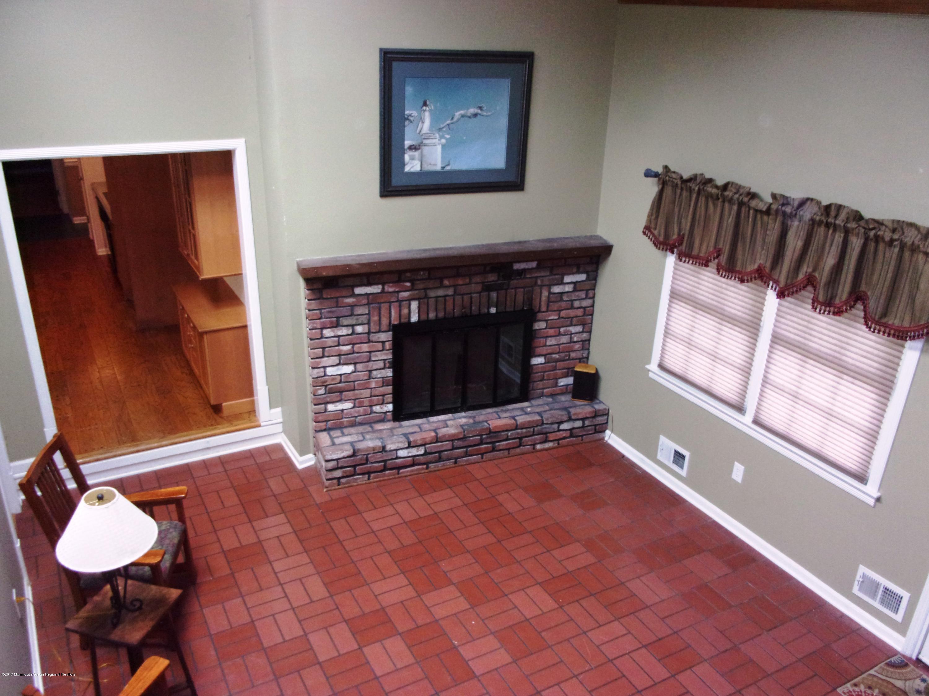 68 Stavola Road Middletown, NJ 07748 - Photo 19 of 49 a living room with furniture a fireplace and a flat screen tv