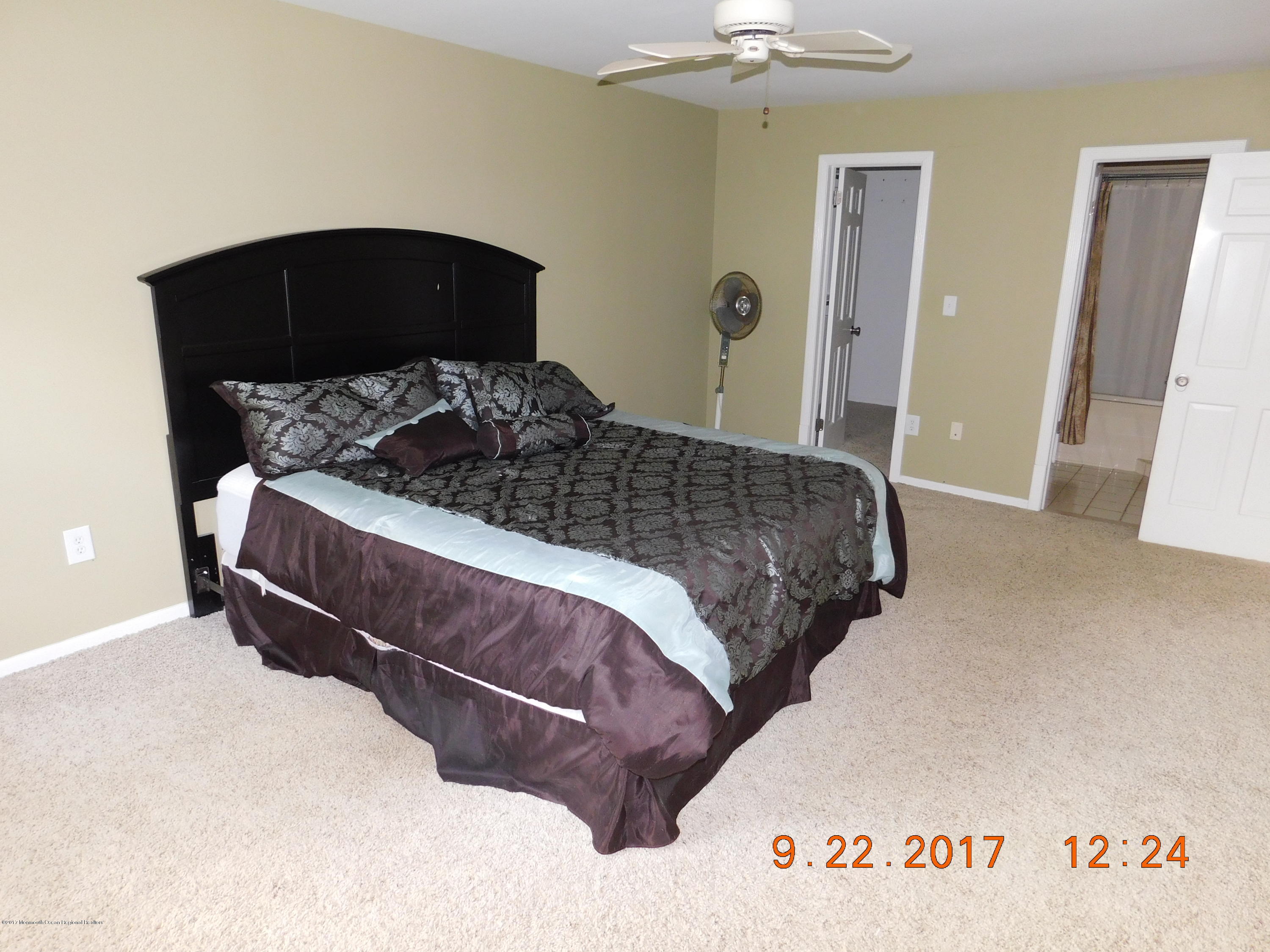 68 Stavola Road Middletown, NJ 07748 - Photo 24 of 49 a bedroom with a bed and lamp