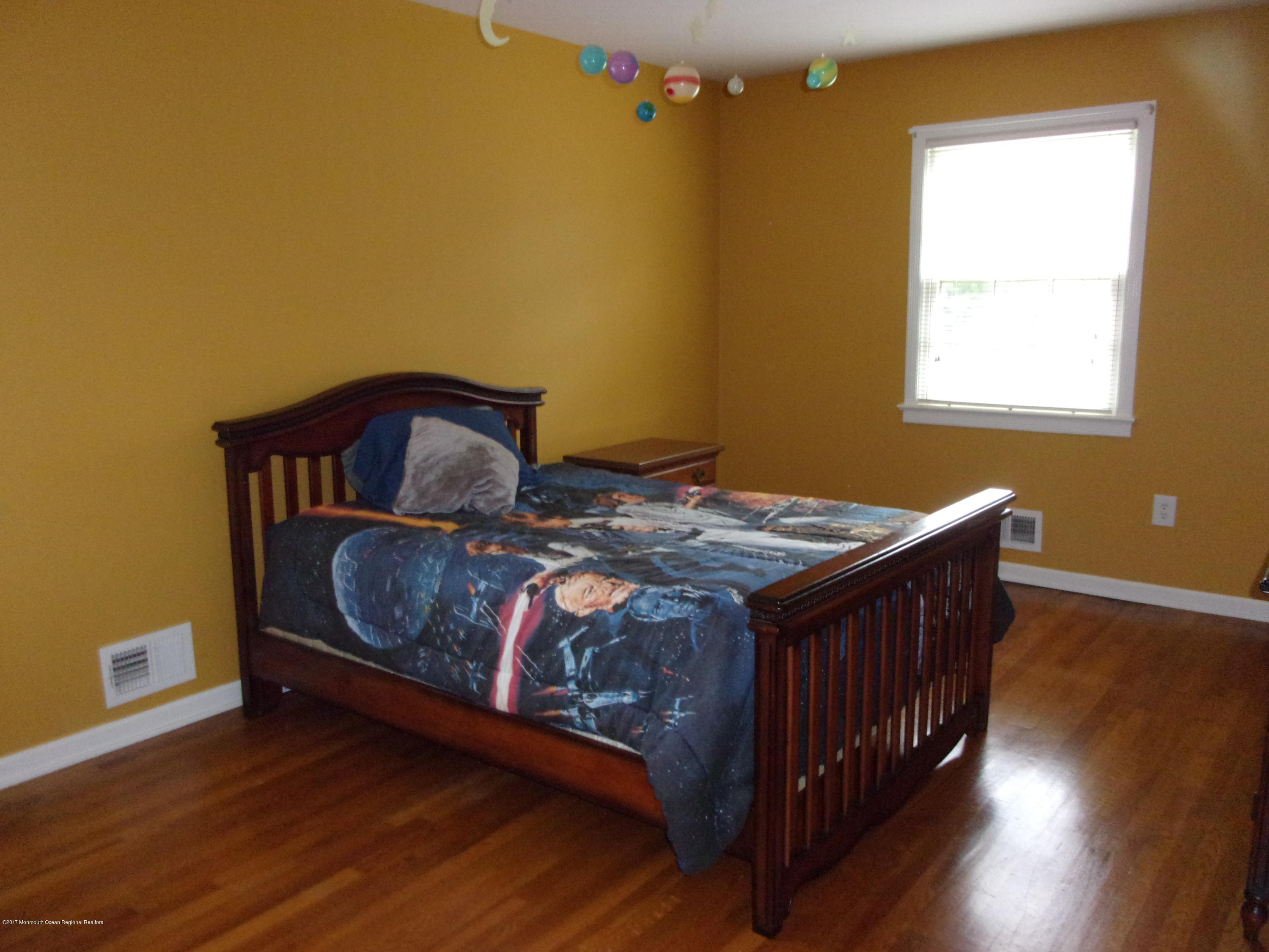 68 Stavola Road Middletown, NJ 07748 - Photo 33 of 49 a bedroom with a bed and wooden floor
