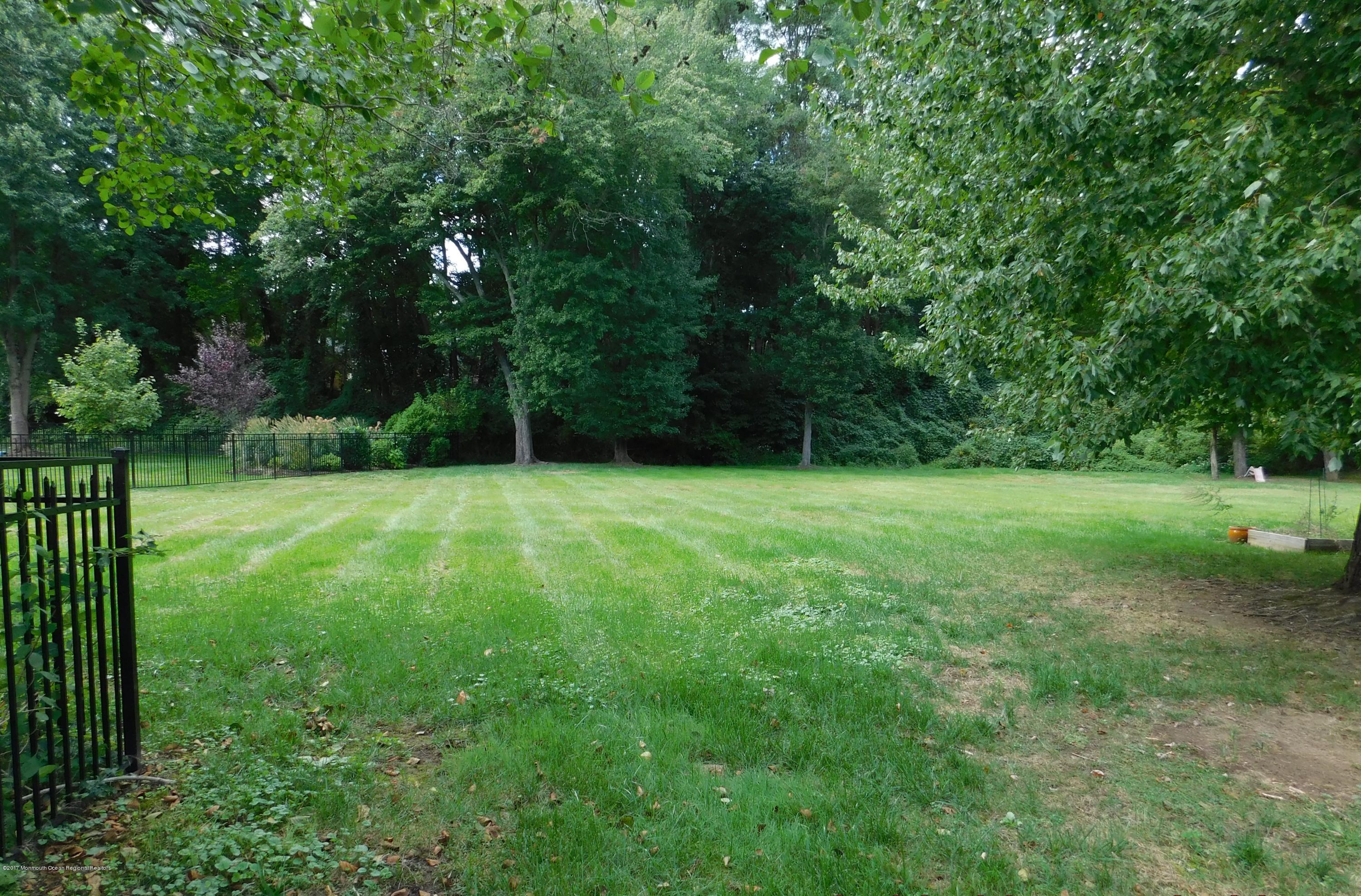 68 Stavola Road Middletown, NJ 07748 - Photo 41 of 49 a view of green field with trees in the background