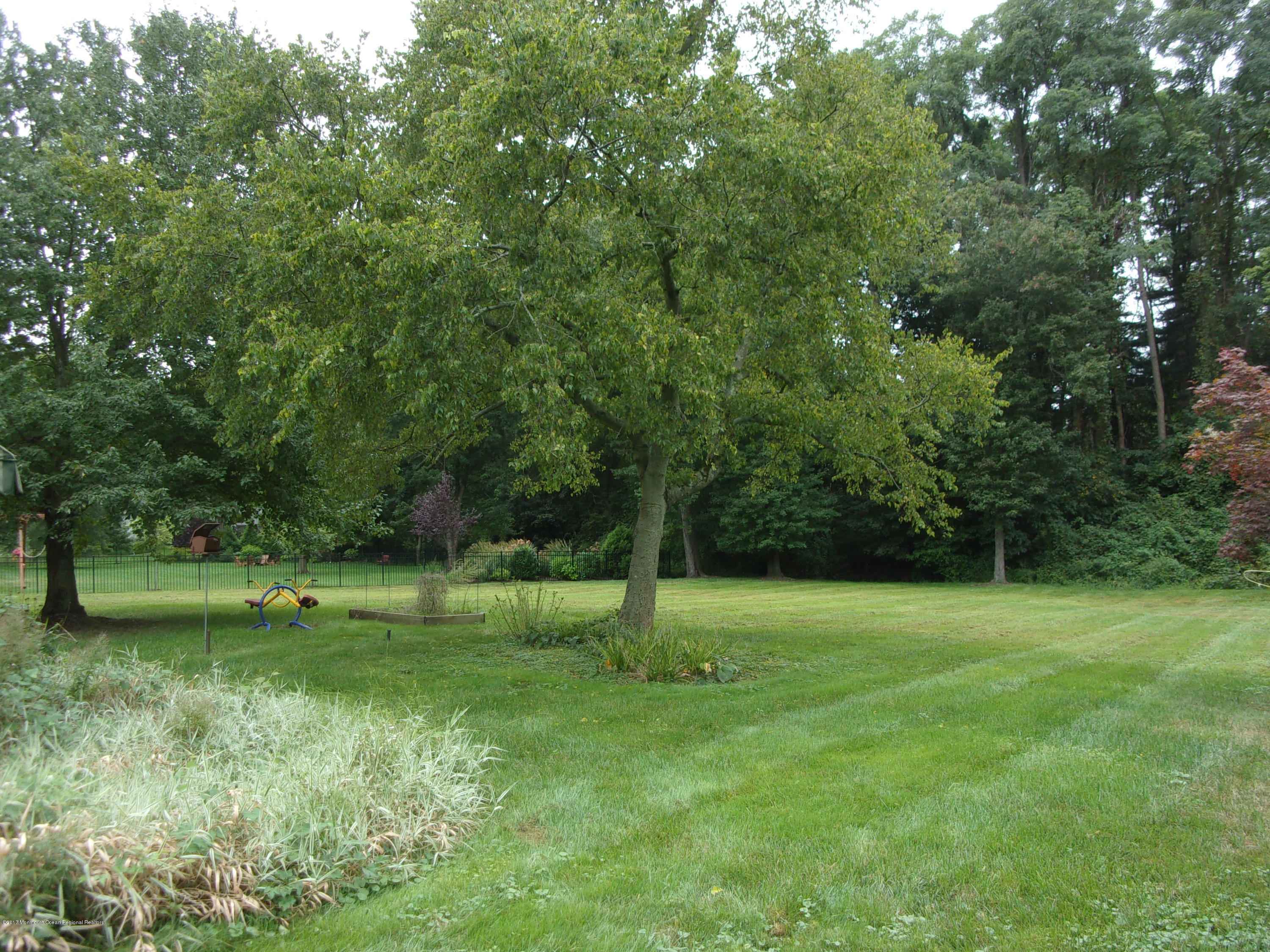 68 Stavola Road Middletown, NJ 07748 - Photo 43 of 49 a backyard of a house with lots of green space and deers