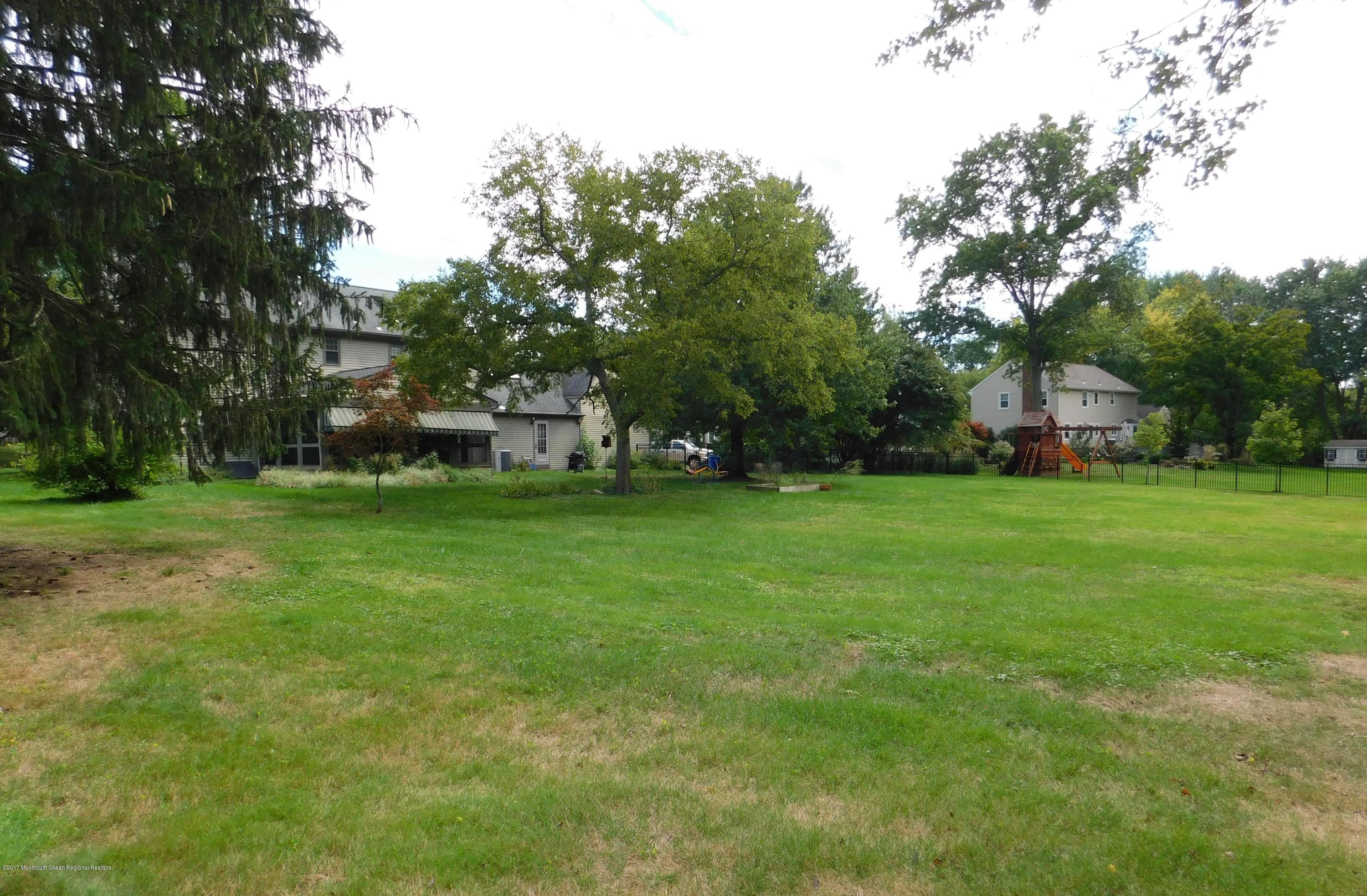 68 Stavola Road Middletown, NJ 07748 - Photo 46 of 49 a view of a green field with wooden fence