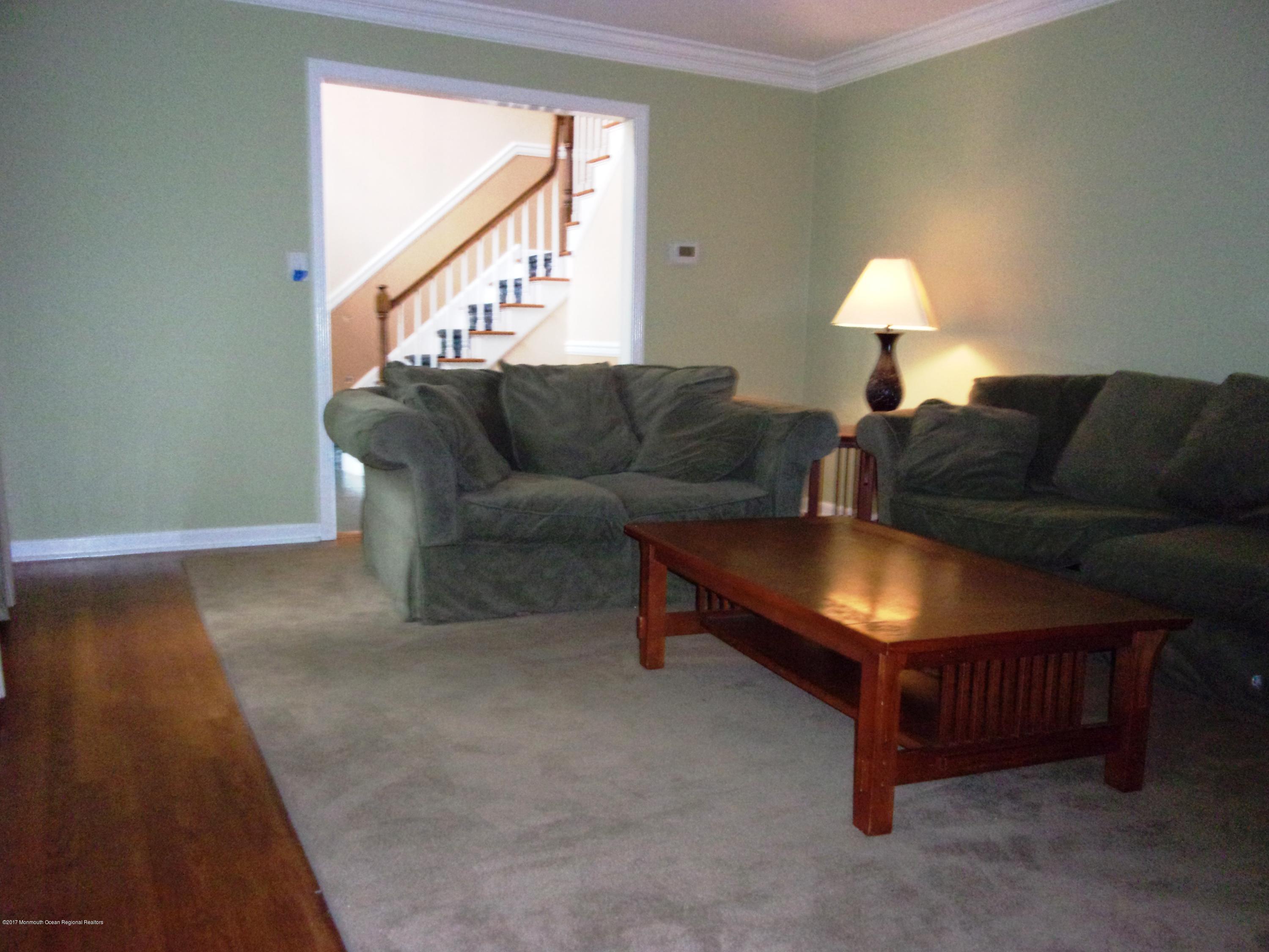 68 Stavola Road Middletown, NJ 07748 - Photo 8 of 49 a living room with furniture and a wooden floor