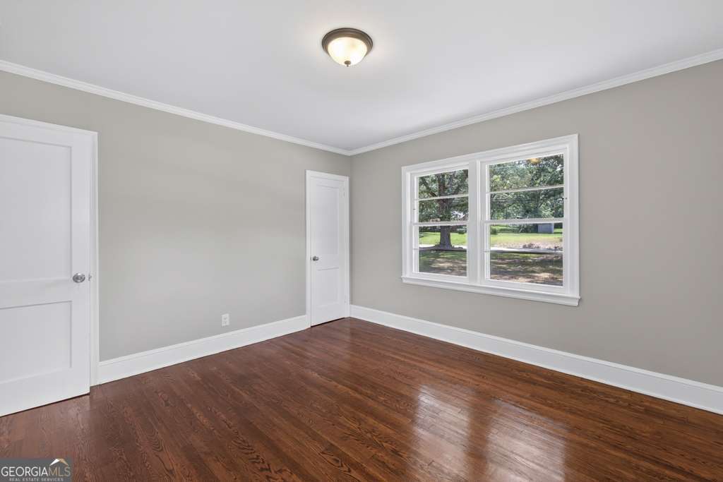 150 Jefferson River Road Athens, GA 30607 - Photo 19 of 76 an empty room with wooden floor and windows