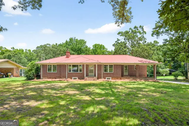 a front view of a house with a garden