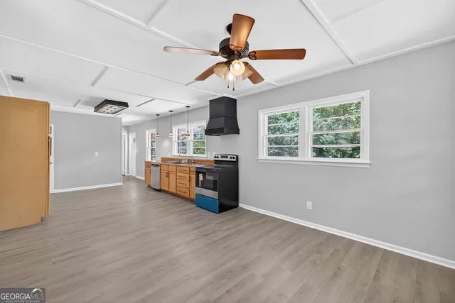 a view of an empty room with wooden floor