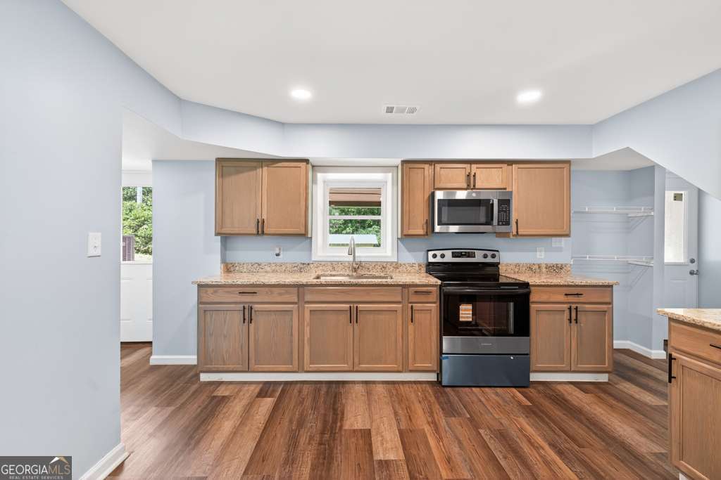 150 Jefferson River Road Athens, GA 30607 - Photo 43 of 76 a kitchen with stainless steel appliances granite countertop a stove a sink and a microwave