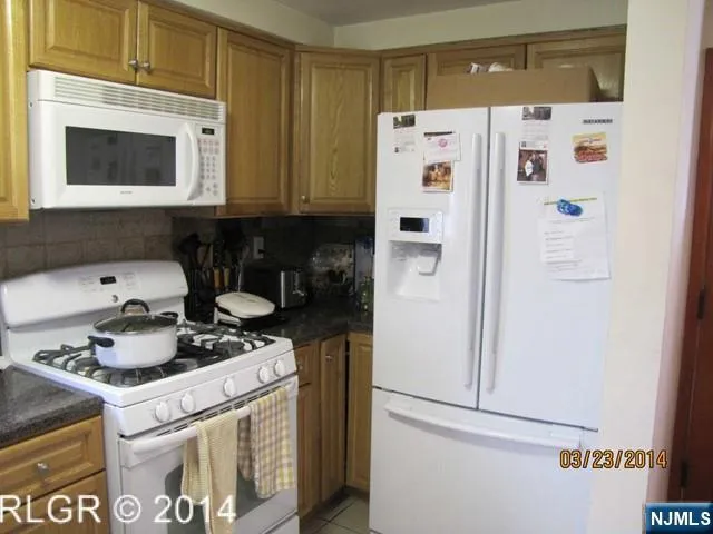 a white refrigerator freezer sitting inside of a kitchen