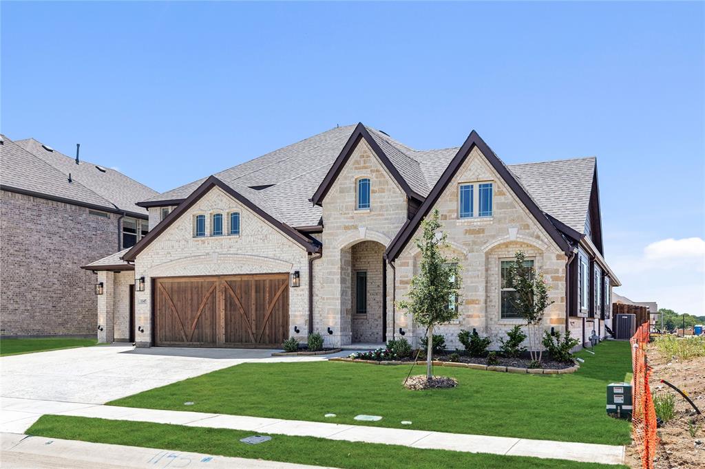 1145 Hitching Post Way Oak Point, TX 75068 - Photo 3 of 39 a front view of a house with a yard