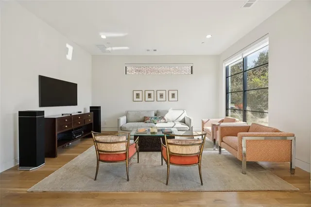 a reading room with furniture a flat screen tv and a window