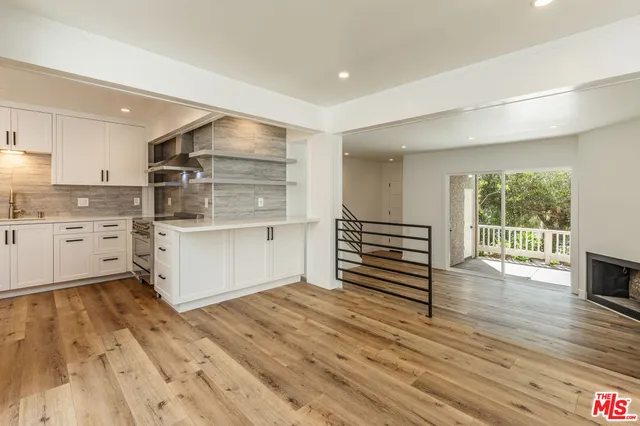 a kitchen with stainless steel appliances a sink and cabinets