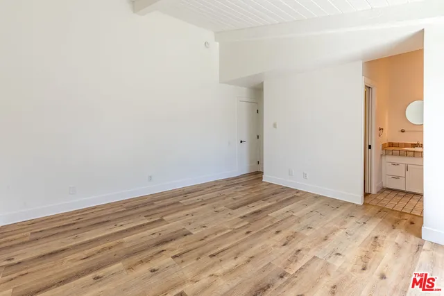 a view of a room with wooden floor and bathroom