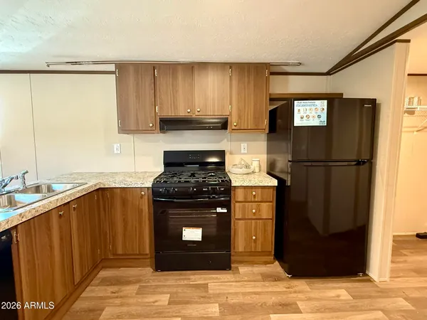 a kitchen with stainless steel appliances granite countertop a refrigerator stove and sink