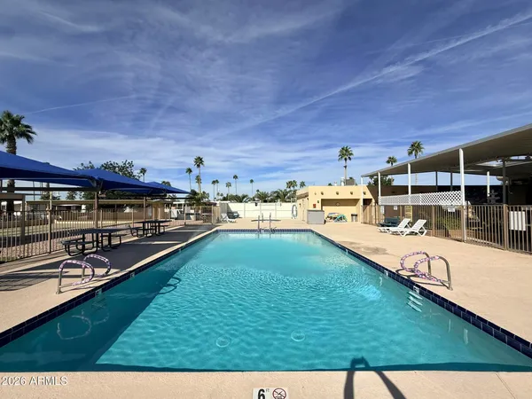 a view of a swimming pool with lawn chairs