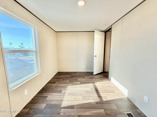 a view of a room with wooden floor and brick walls