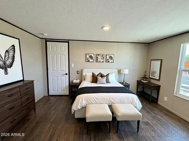 a bedroom with bed and wooden floor