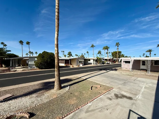 a view of a patio with table and chairs under an umbrella