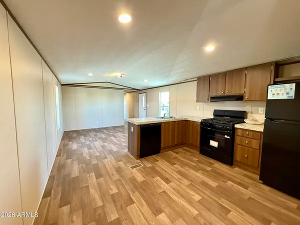a kitchen with stainless steel appliances granite countertop a refrigerator and a sink
