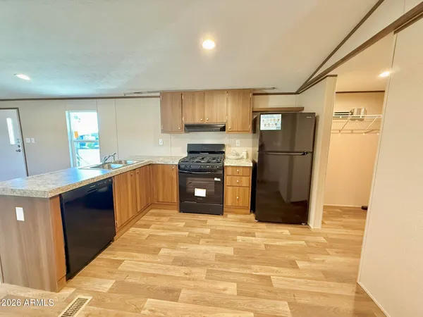 a kitchen with a refrigerator and a sink