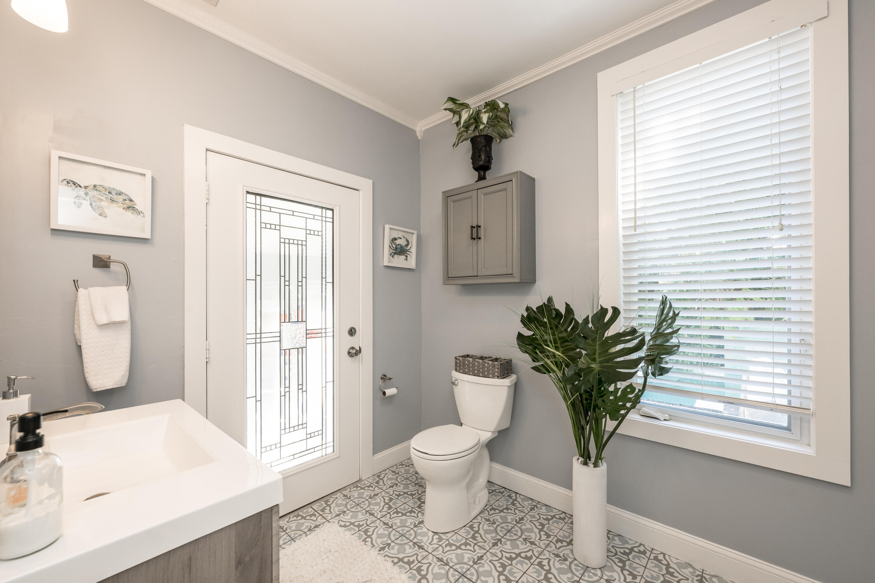 1416 Catherine Street Key West, FL 33040 - Photo 16 of 53 a bathroom with a toilet a sink and a large mirror