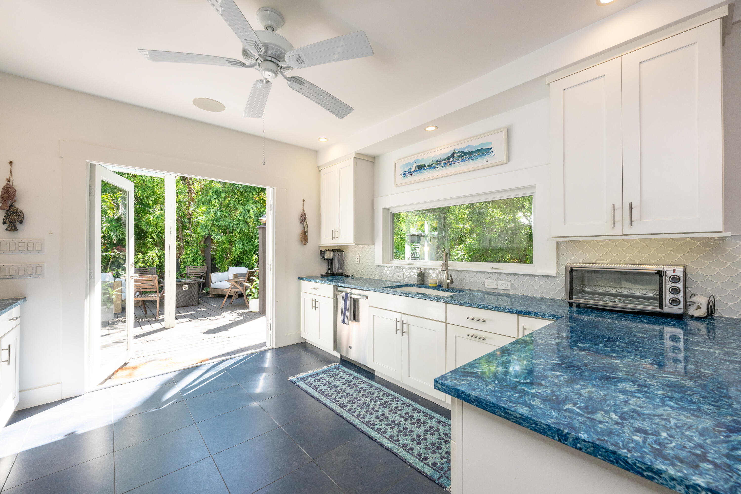 1416 Catherine Street Key West, FL 33040 - Photo 3 of 53 a kitchen with stainless steel appliances granite countertop a stove a sink and a microwave