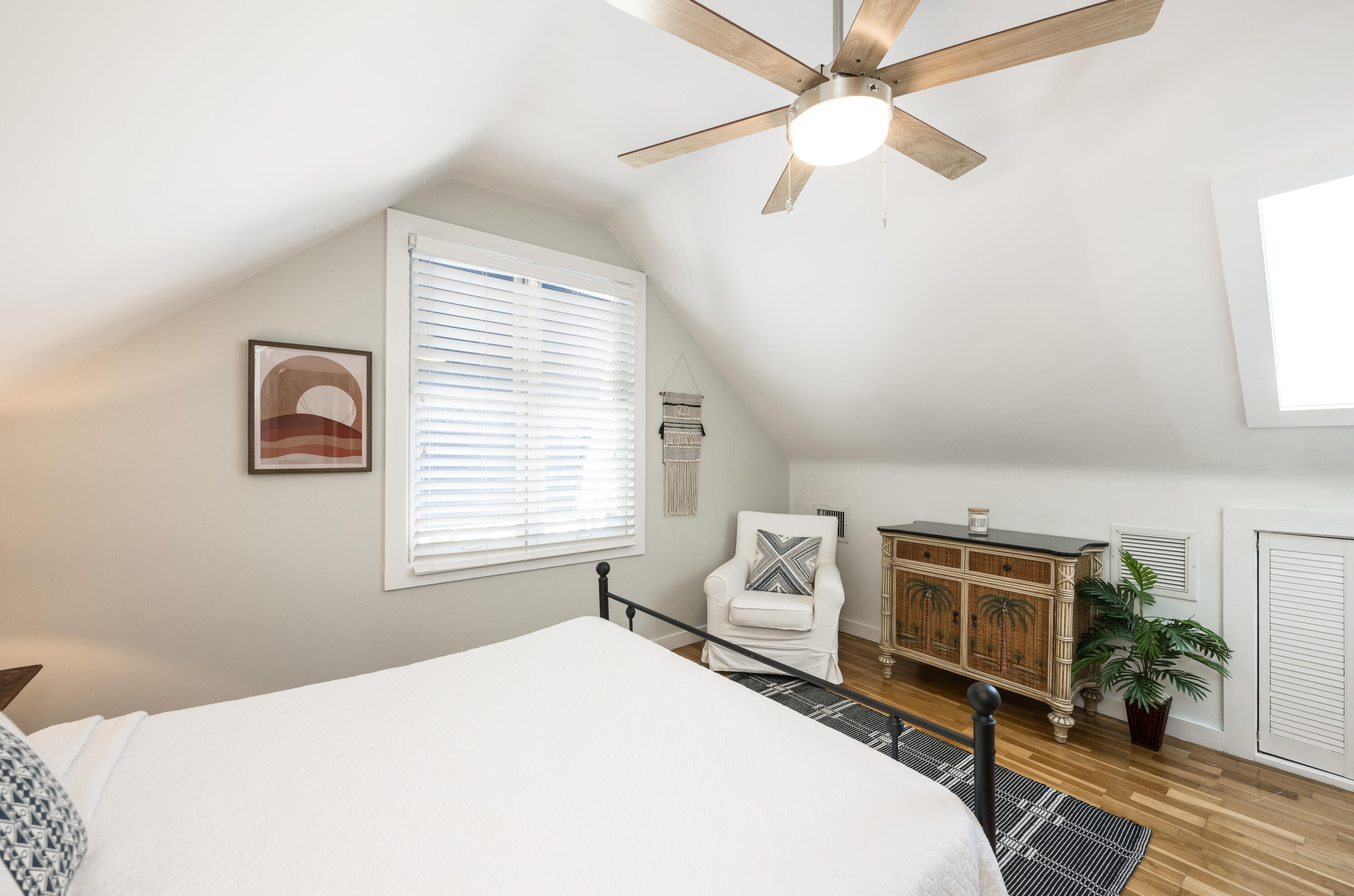 1416 Catherine Street Key West, FL 33040 - Photo 39 of 53 a bedroom with a bed a chandelier a chair and potted plant on the dresser