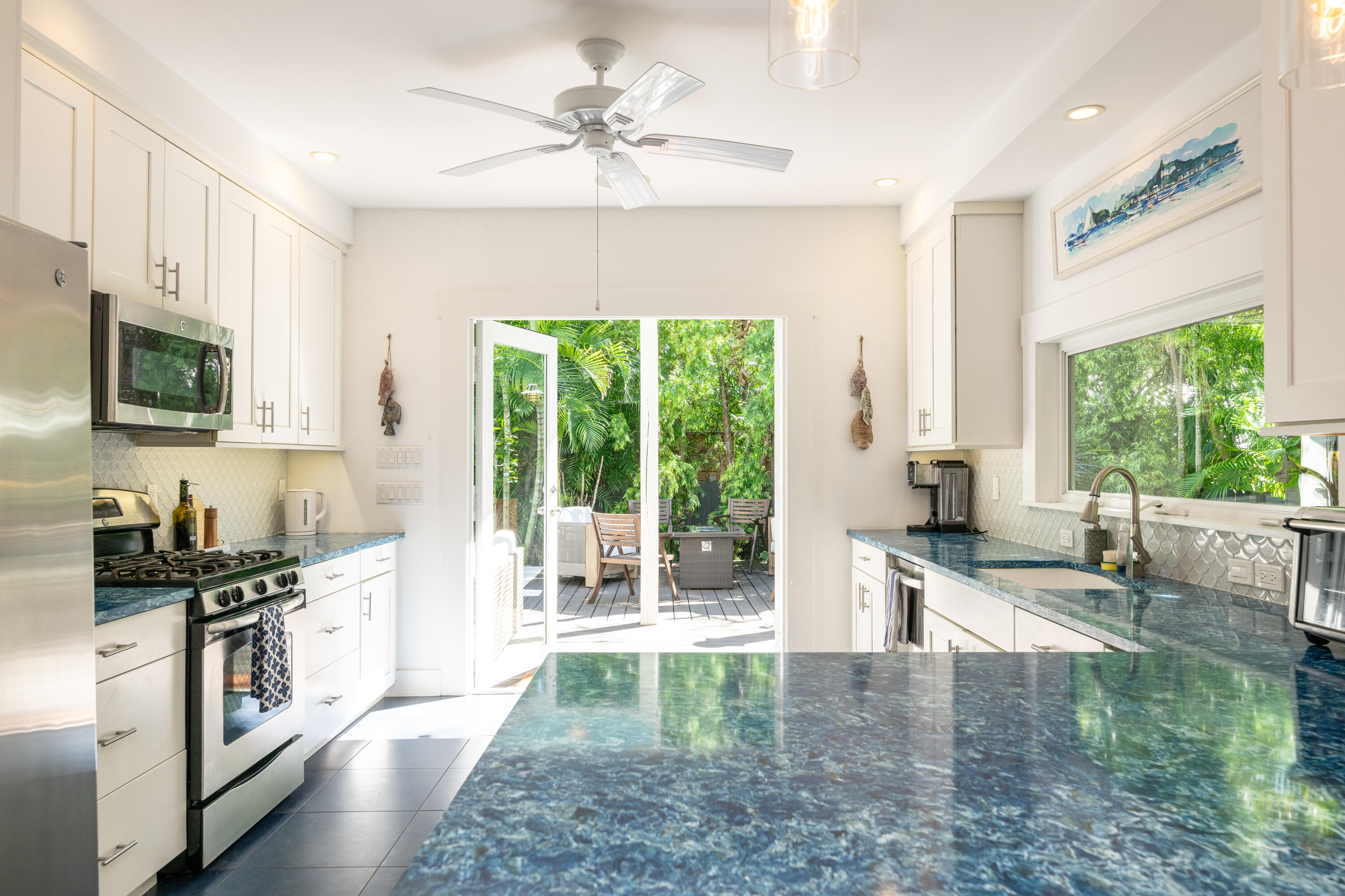 1416 Catherine Street Key West, FL 33040 - Photo 7 of 53 a kitchen with granite countertop a stove a sink and a refrigerator