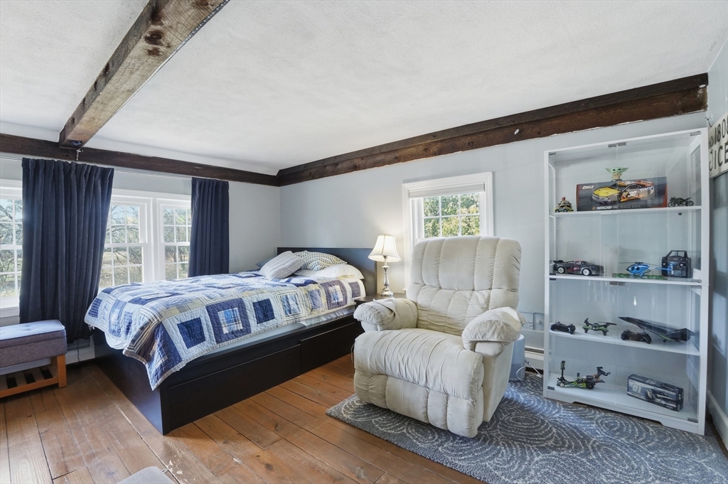61 Main Street Hanover, MA 02339 - Photo 23 of 38 a bedroom with a bed and a window
