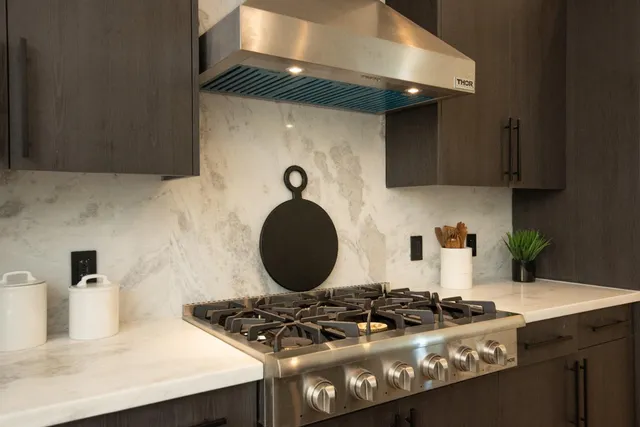a view of a room with wooden floor and bathroom sink