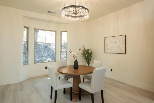 a bathroom with a double vanity sink a mirror and a bathtub