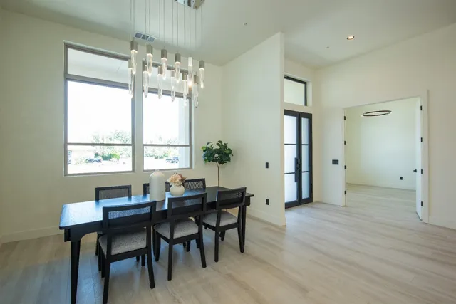 a large white bathroom with a double vanity sink a mirror and a bathtub