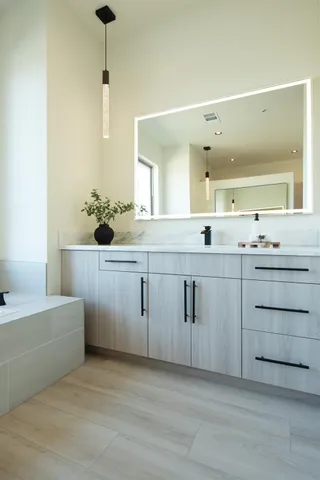 an empty room with a window and a ceiling fan