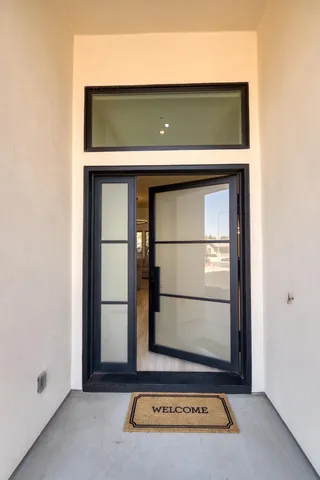 a living room with furniture kitchen and a chandelier