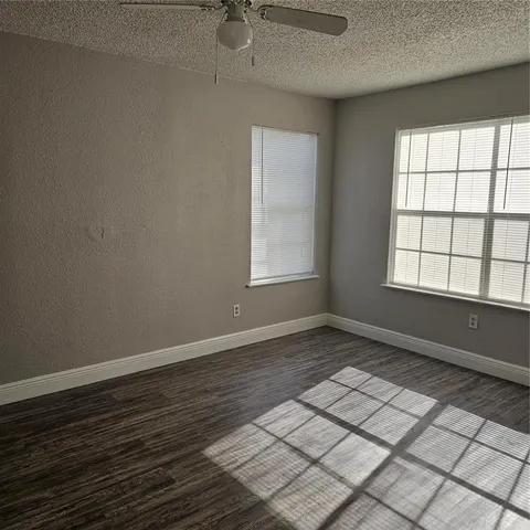 an empty room with wooden floor and closet