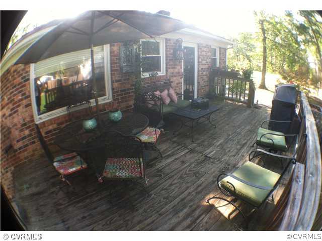 10430 Ambridge Road Chesterfield, VA 23832 - Photo 16 of 18 a view of a patio with table and chairs under an umbrella