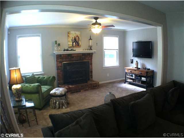 10430 Ambridge Road Chesterfield, VA 23832 - Photo 3 of 18 a living room with furniture a flat screen tv and a fireplace