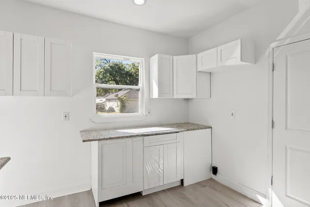 a utility room with cabinets washer and dryer